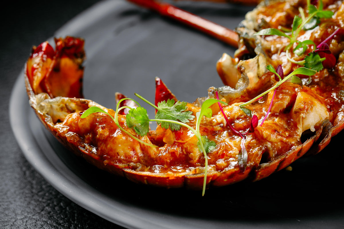 Cooked lobster tail garnished with herbs